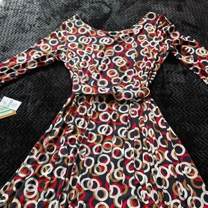 Multi color dress 90% Polyester and 5% Spandex.Belt closure.